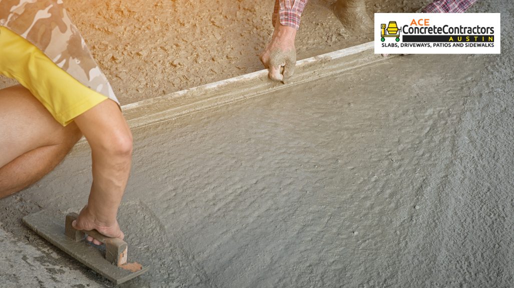 person smoothening wet concrete using trowel 